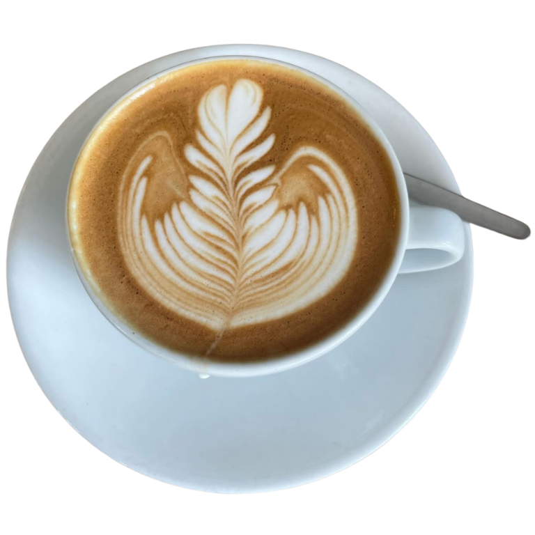 Coffee A cup of coffee with a leaf design on top